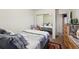A bedroom with a mirorred closet and dark red rug at 5995 W Hampden Ave # 13G, Denver, CO 80227