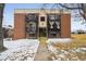 Brick apartment building with balconies, stairs, and landscaping at 5995 W Hampden Ave # 13G, Denver, CO 80227