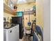 A laundry room with a blue laundry basket and a washer and dryer at 5995 W Hampden Ave # 13G, Denver, CO 80227
