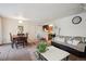 Comfortable living room featuring hardwood table with chairs and a cozy sofa at 5995 W Hampden Ave # 13G, Denver, CO 80227