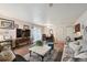 Sunny living room area with sofas, dining table, and neutral walls at 5995 W Hampden Ave # 13G, Denver, CO 80227