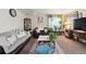 Inviting living room featuring neutral walls, plush sofas, area rug, and natural light at 5995 W Hampden Ave # 13G, Denver, CO 80227