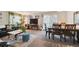 Open-concept living room with sofas, table, dining table, and sliding glass door at 5995 W Hampden Ave # 13G, Denver, CO 80227