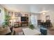 Bright and sunny living room area with sofas, dining table, and neutral walls at 5995 W Hampden Ave # 13G, Denver, CO 80227