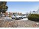 Exterior view showcasing a parking lot with a sign and well-maintained apartment building at 5995 W Hampden Ave # 13G, Denver, CO 80227