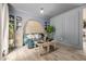 Bright living room featuring a blue accent wall with built-in shelving and wood floors at 16051 E Alabama Dr, Aurora, CO 80017