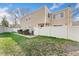 Charming home with a fenced yard and well-maintained lawn, providing a welcoming curb appeal at 9675 E Kansas Cir # 45, Denver, CO 80247