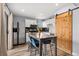 Modern kitchen featuring white cabinets, stainless steel appliances, and a barn door at 9675 E Kansas Cir # 45, Denver, CO 80247