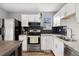 Beautiful kitchen with stainless steel appliances and modern backsplash and countertops at 9675 E Kansas Cir # 45, Denver, CO 80247
