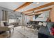 Spacious living room with exposed beams and sliding door leading to outdoor patio at 9675 E Kansas Cir # 45, Denver, CO 80247