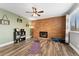 Inviting living room with a brick fireplace, ceiling fan, and natural light, perfect for relaxation at 9675 E Kansas Cir # 45, Denver, CO 80247