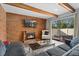 Bright living room featuring a brick fireplace and access to outdoor patio at 9675 E Kansas Cir # 45, Denver, CO 80247