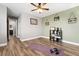 Open living room with updated wood floors and ceiling fan, flows to connected rooms and bathroom at 9675 E Kansas Cir # 45, Denver, CO 80247