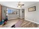 Bright living room with large window, ceiling fan and wood-look flooring provides an exercise space at 9675 E Kansas Cir # 45, Denver, CO 80247