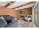 Inviting living room featuring a brick fireplace and sliding glass door for natural light at 9675 E Kansas Cir # 45, Denver, CO 80247