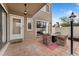Cozy patio area with brick pavers and comfortable seating around a modern fire pit at 9675 E Kansas Cir # 45, Denver, CO 80247