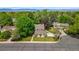 Aerial view of a home in a lush neighborhood with mature trees, showcasing the property's landscaping and location at 9951 Winona St, Westminster, CO 80031