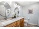 Bright bathroom with double sink vanity, granite counters, modern fixtures, and wood-look tile at 9951 Winona St, Westminster, CO 80031