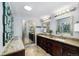 Primary bath features a double vanity with granite countertops, dual mirrors and ample lighting at 9951 Winona St, Westminster, CO 80031