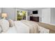Sunlit bedroom featuring a private balcony, neutral walls, and a large dark wood dresser at 9951 Winona St, Westminster, CO 80031