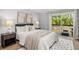 Bright bedroom featuring neutral tones, a sliding glass door to the deck, and contemporary furnishings at 9951 Winona St, Westminster, CO 80031