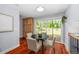 Bright breakfast nook featuring a round table, wood floors, and sliding doors to the backyard deck at 9951 Winona St, Westminster, CO 80031