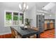 Bright dining area featuring a dark wood table, modern chandelier, and view of the backyard at 9951 Winona St, Westminster, CO 80031