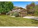 Charming home featuring a well-maintained lawn, mature landscaping, a paved driveway, and a two-car garage at 9951 Winona St, Westminster, CO 80031