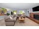Comfortable living room featuring brick fireplace, built-in shelves, and sectional sofa at 9951 Winona St, Westminster, CO 80031