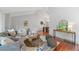 Spacious living room featuring vaulted ceilings, a modern sofa, stylish decor, and hardwood floors at 9951 Winona St, Westminster, CO 80031