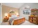 This cozy bedroom features a wood frame bed, natural light from a large window, and ample storage at 6911 Chestnut Ct, Parker, CO 80134