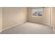 An unfurnished bedroom with neutral carpet, paint and window at 6911 Chestnut Ct, Parker, CO 80134