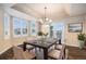 Elegant dining room with hardwood floors, tray ceilings and natural light from bay windows at 6911 Chestnut Ct, Parker, CO 80134