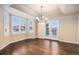 Bright, open dining room featuring tray ceilings, hardwood floors, and French doors to deck at 6911 Chestnut Ct, Parker, CO 80134