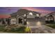 Charming two-story home featuring a three-car garage, brick accents, and a beautifully landscaped front yard at 6911 Chestnut Ct, Parker, CO 80134