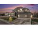 Charming two-story home featuring a three-car garage, brick accents, and a beautifully landscaped front yard at 6911 Chestnut Ct, Parker, CO 80134