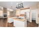 Open kitchen layout with hardwood floors, granite countertops, stainless steel appliances, and a breakfast bar at 6911 Chestnut Ct, Parker, CO 80134