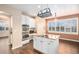 Kitchen featuring stainless steel appliances, tile backsplash, granite countertops, a cooking island, and ample natural light at 6911 Chestnut Ct, Parker, CO 80134