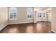 Spacious living room featuring hardwood floors, large windows with plantation shutters at 6911 Chestnut Ct, Parker, CO 80134