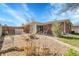 Spacious backyard with patio, mature trees, grass, and partially fenced yard at 3022 Blackhawk St, Aurora, CO 80011