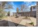 Cozy backyard with a small fire pit, a bench, and some charming decorative features at 3022 Blackhawk St, Aurora, CO 80011