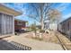 Beautiful backyard with concrete patio, fire pit, mature trees, and partially fenced in area at 3022 Blackhawk St, Aurora, CO 80011