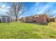 Large backyard showcasing a brick house and a gray storage shed at 3022 Blackhawk St, Aurora, CO 80011