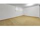 A carpeted basement features white walls and window for a room to customize to your needs at 3022 Blackhawk St, Aurora, CO 80011
