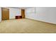 Finished basement space has carpet flooring, cabinets, and door perfect for storage at 3022 Blackhawk St, Aurora, CO 80011