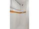 Shower includes white tiling with orange accent and silver shower head and handle at 3022 Blackhawk St, Aurora, CO 80011