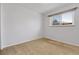Empty bedroom with carpet flooring, white walls, and window at 3022 Blackhawk St, Aurora, CO 80011