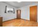 Well-lit bedroom featuring hardwood floors and a window with natural light at 3022 Blackhawk St, Aurora, CO 80011