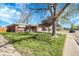 Attractive brick home with a lush green lawn, mature trees, and a welcoming front entry at 3022 Blackhawk St, Aurora, CO 80011