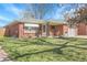Charming brick home with a well-manicured lawn and inviting front porch, perfect for relaxing at 3022 Blackhawk St, Aurora, CO 80011